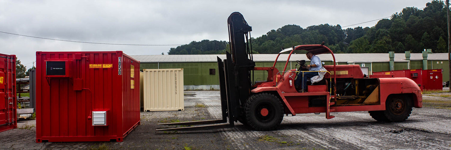 Forklift moving Hazmat Storage unit