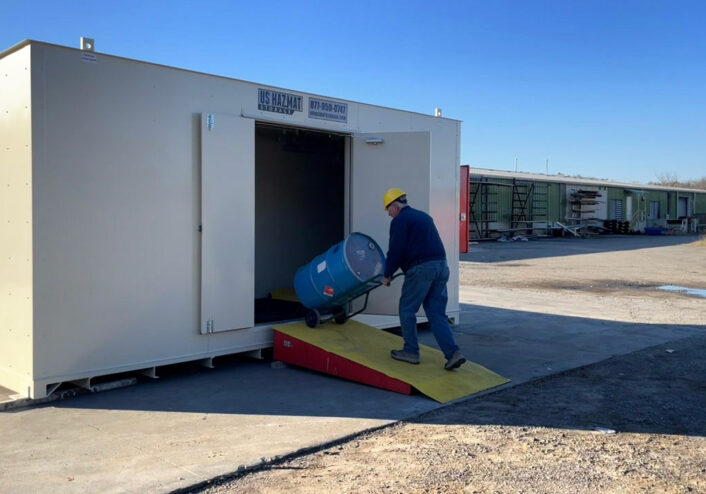 Wheeling chemical storage barrel into hazardous drum storage unit