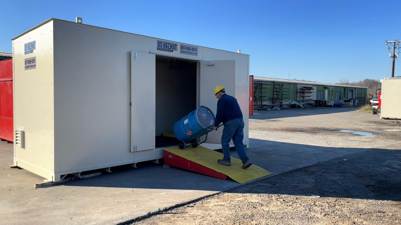 Wheeling chemical storage barrel into hazardous drum storage unit