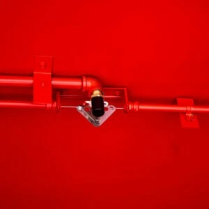 Fire suppression agent tank installed in a hazmat storage building