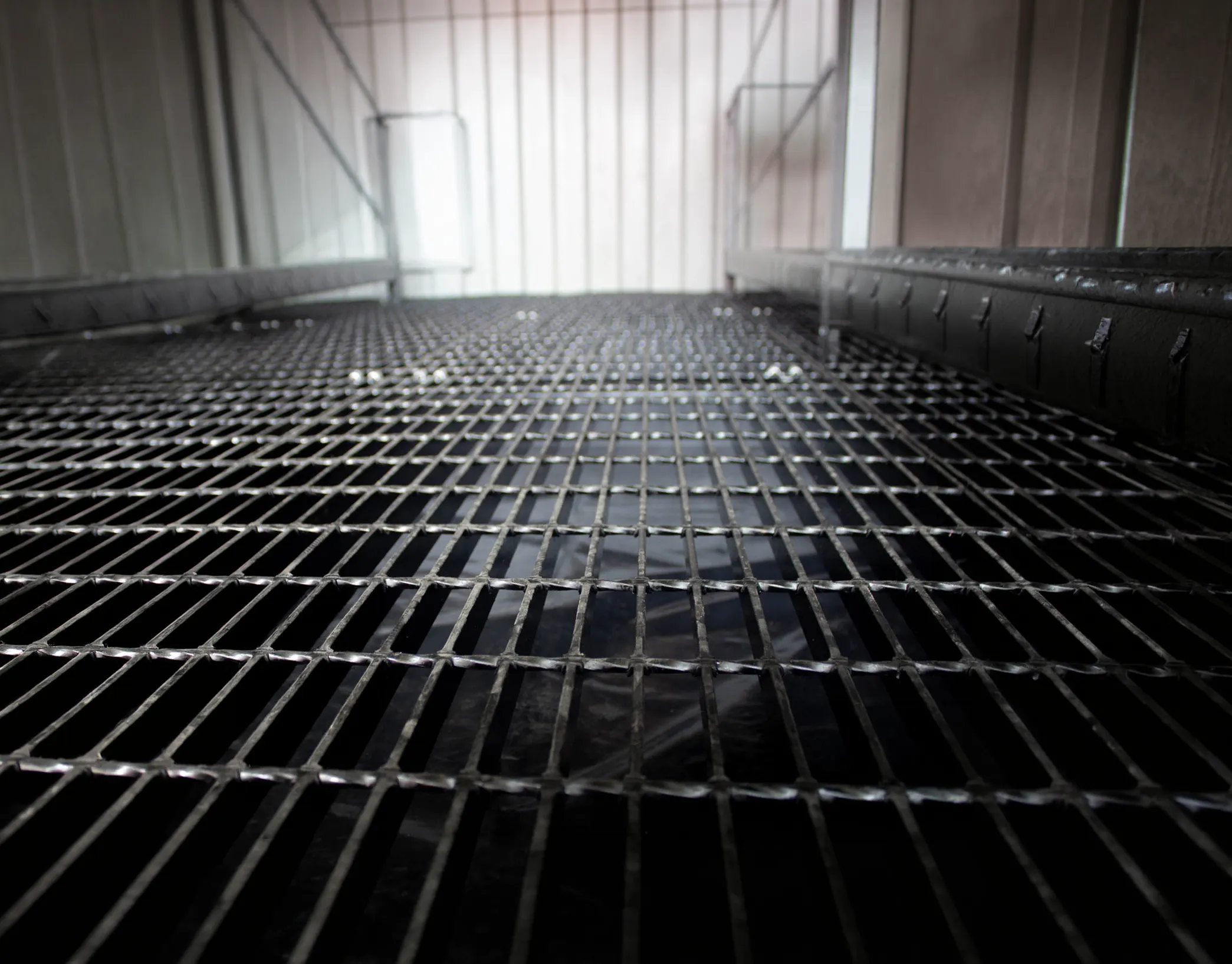 Grated floor sump for EPA secondary containment in a hazmat storage building